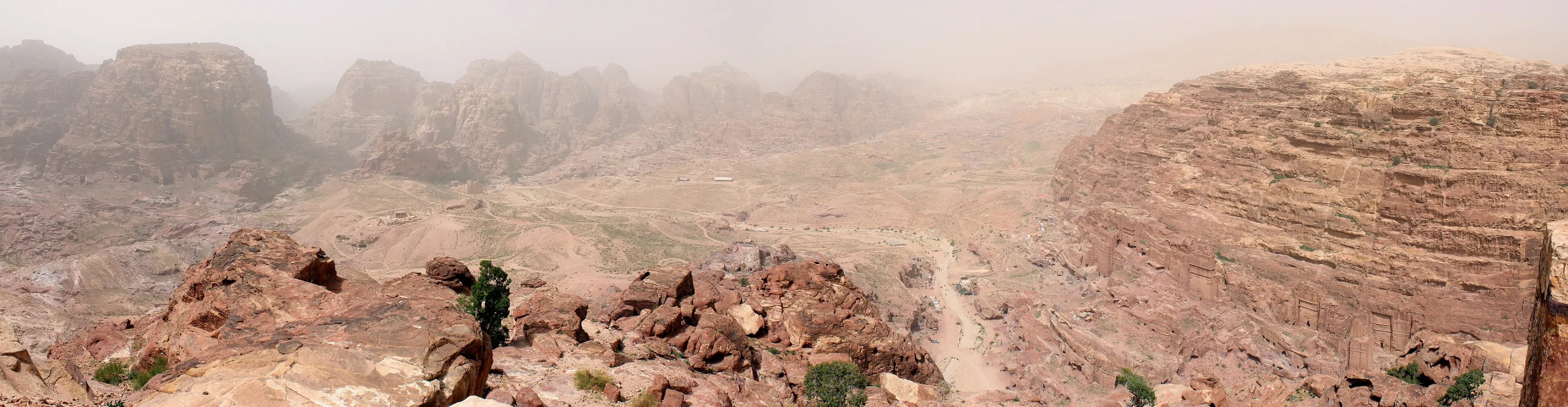 A wide panorama across the main-trail area and sandstone landscape of Petra